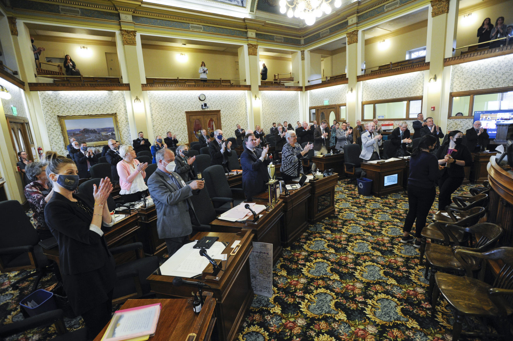 Senators stand and clap after the Sine Die vote on Thursday, April 29, 2021.